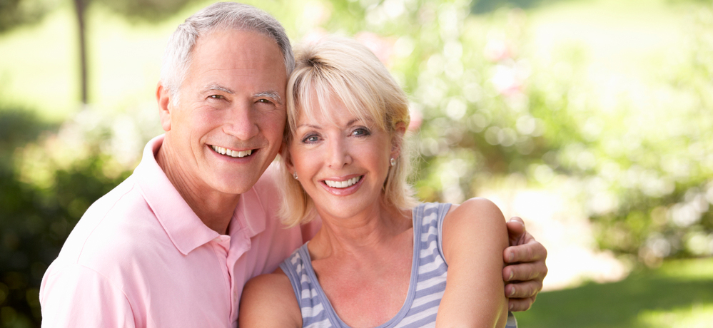 happy older couple smiling with healthy teeth after Marco Island full mouth reconstruction